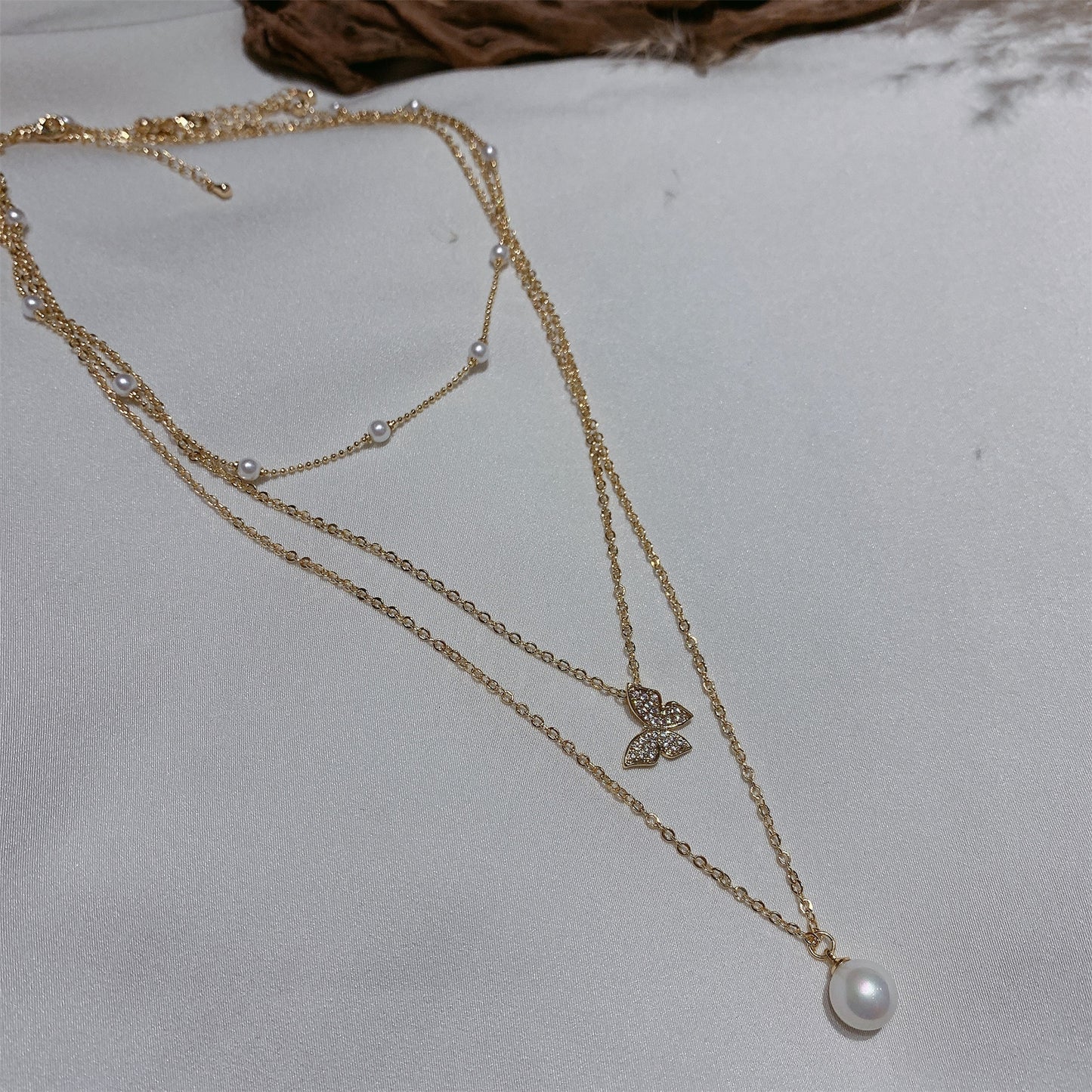 Multi-layered butterfly pearl necklace